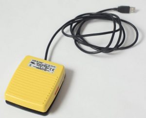 a yellow USB foot pedal for transcription